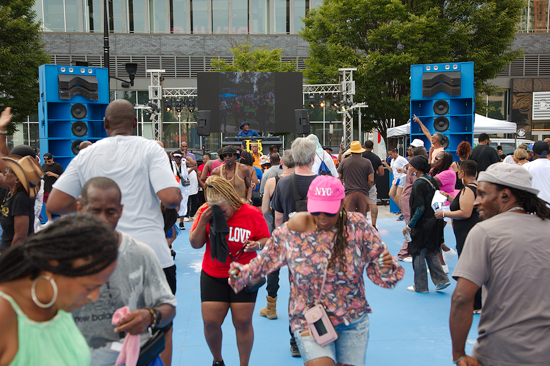 a crowd of people dancing on an outdoor dance floor